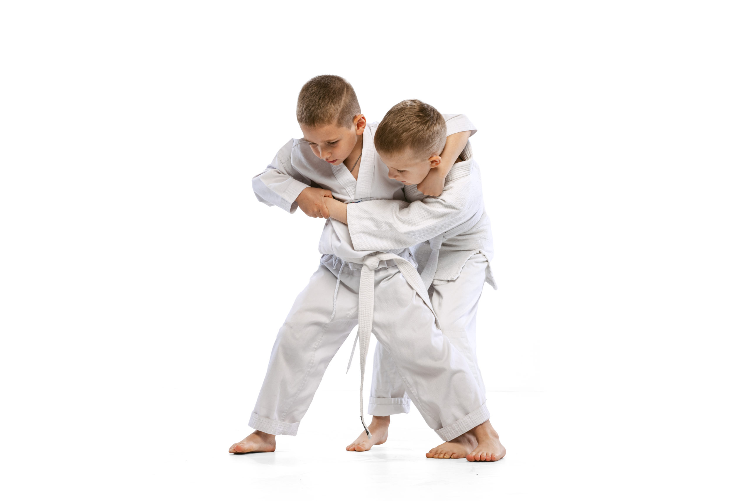 //mkkoyama.pl/wp-content/uploads/2023/09/two-boys-children-fighting-training-martial-sport-karate-isolated-white-studio-background-1-scaled.jpg